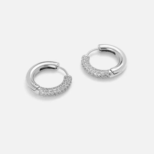 Silver pavé cubic zirconia huggie hoop earrings, pair on studio background