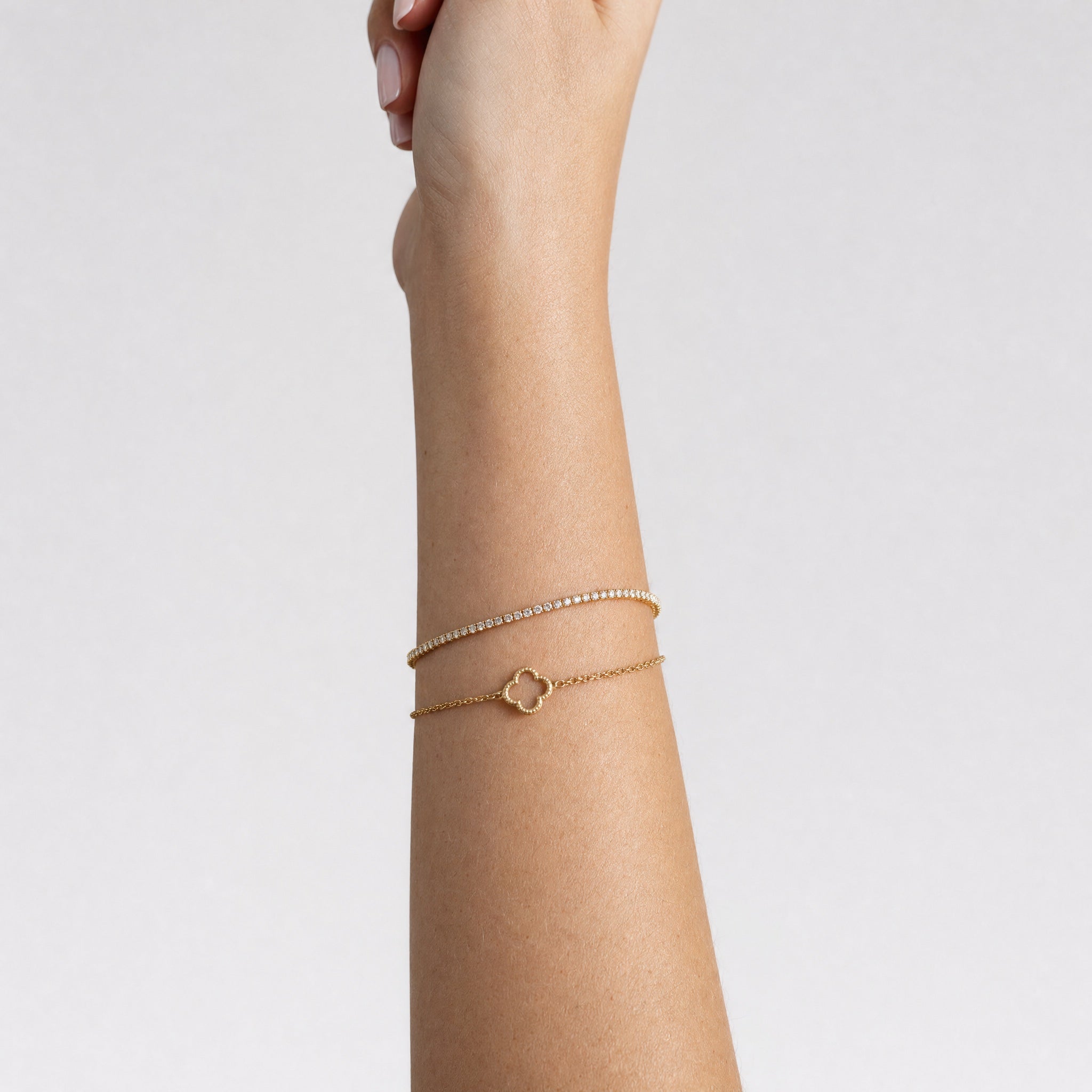 Delicate gold tennis and clover bracelets
